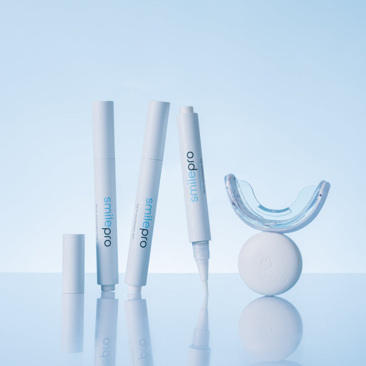 SmilePro teeth whitening pens beside the LED mouthpiece and light